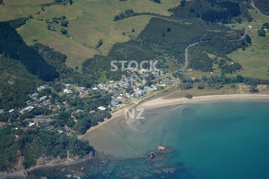 Aerial photo of Oakura in Northland - Houses and beach at the Rapata Road end of Oakura Bay, a small coastal settlement in Whangarei District