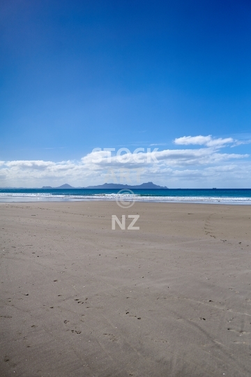 Bream Bay beach at Waipu Cove - Northland, NZ - White sand at low tide and the Whangarei Heads in the background