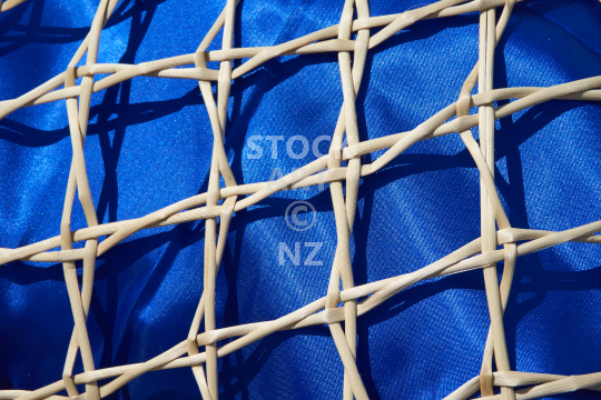 Closeup of a kupenga knot kete with blue lining