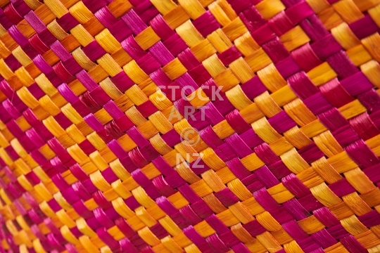 Closeup of orange magenta flax weaving - Closeup of a kete from New Zealand