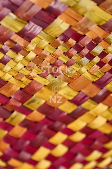 Closeup of red and yellow flax weaving - Woven background in portrait orientation