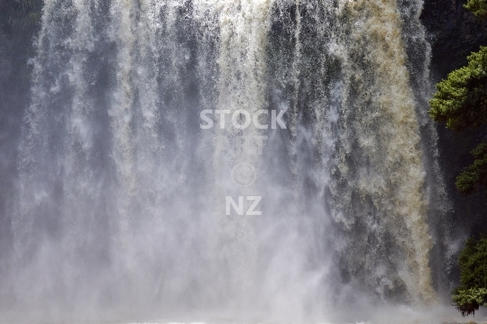 Closeup of the Whangarei Falls  - Gushing water and spray from the 26 metre waterfall in Northland, New Zealand