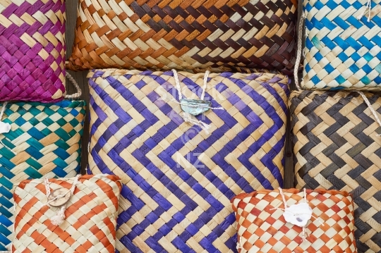 Flax weaving - pikau and kete - Group of colourful woven flax bags and backpacks