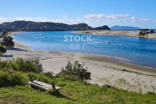 Mangawhai estuary and sandspit - Old lookout bench along the waterfront walk above the estuary, part of the Te Araroa Trail