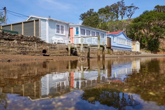 Typical Kiwi bach stock photo - Waterfront holiday homes in Whananaki, Northland, New Zealand